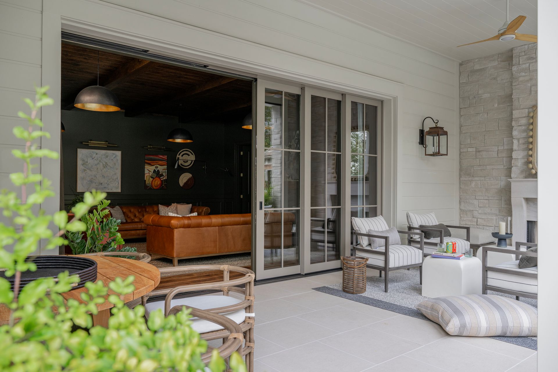 A patio with sliding glass doors leading to a living room.