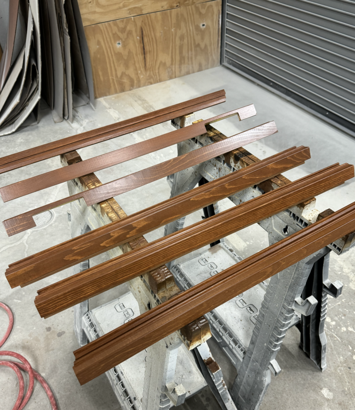 A bunch of wooden boards are sitting on top of each other on a table.