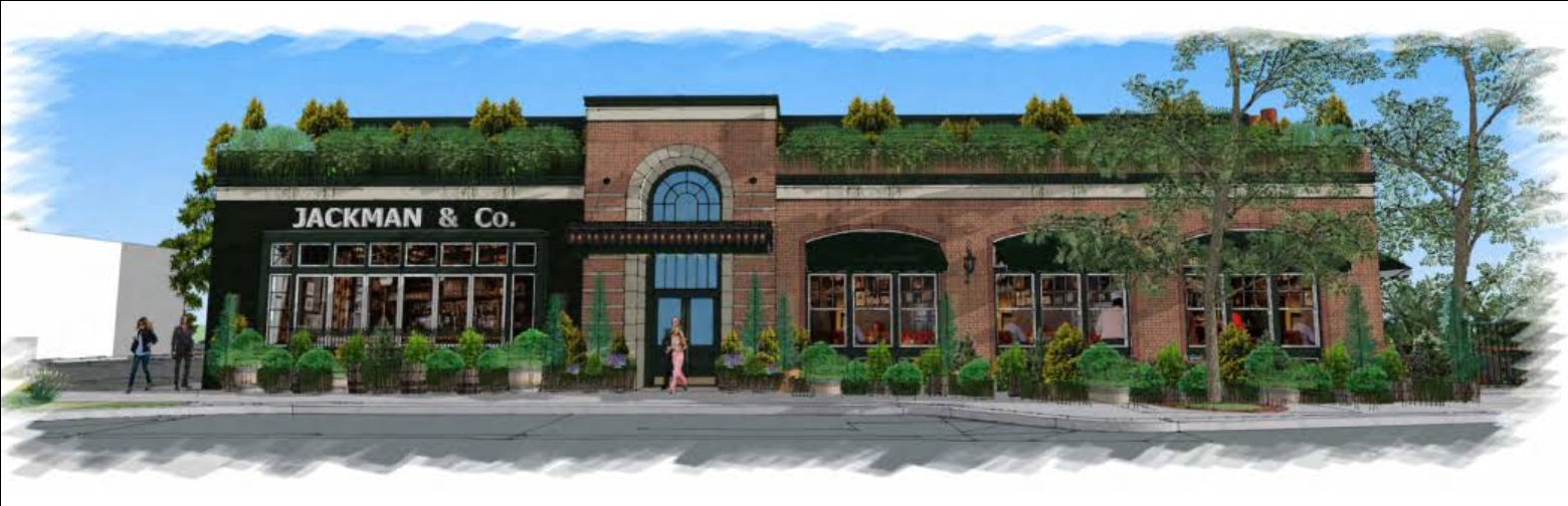 Building exterior with a green roof, brick and black facade, and large windows.