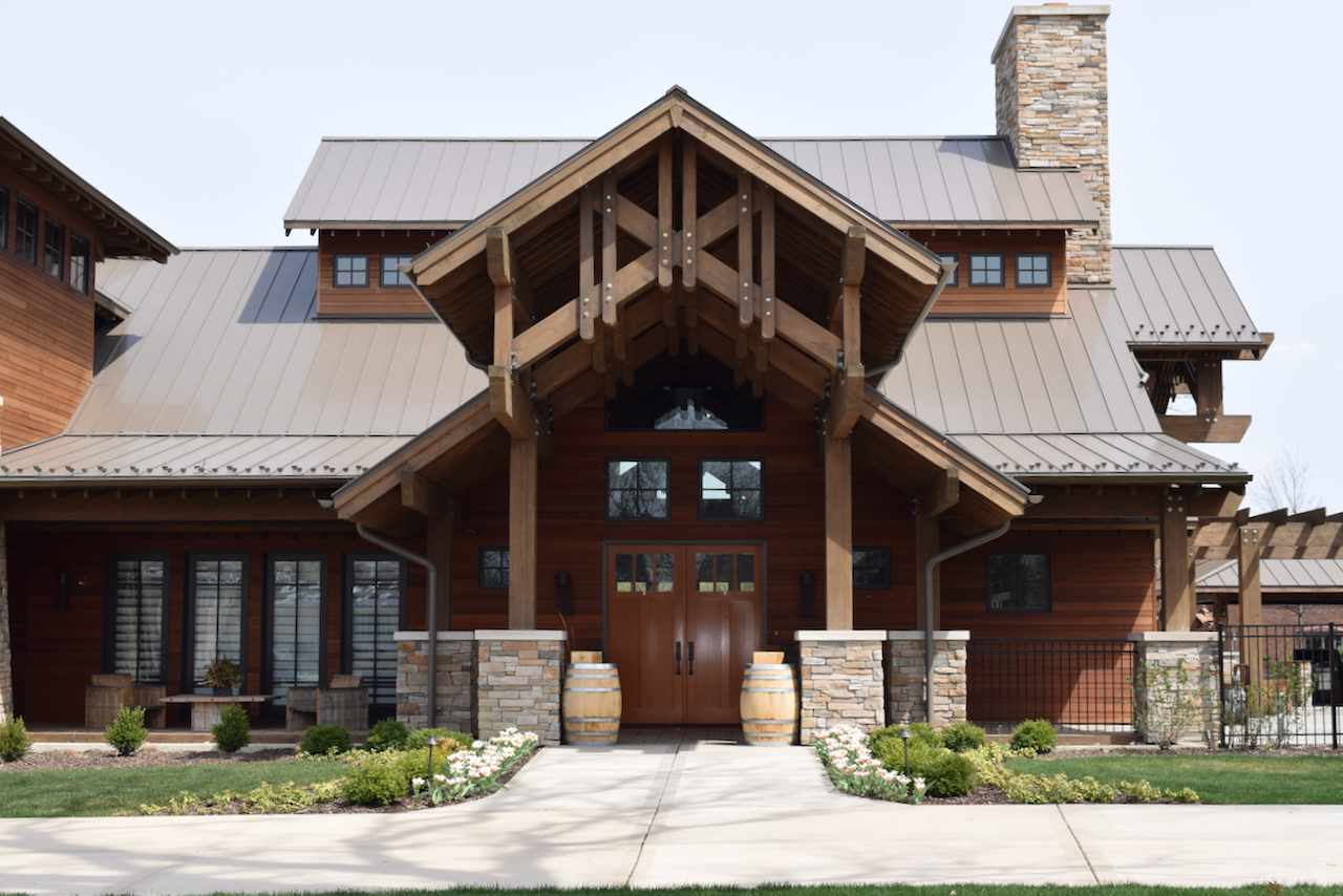 A large wooden house with a metal roof