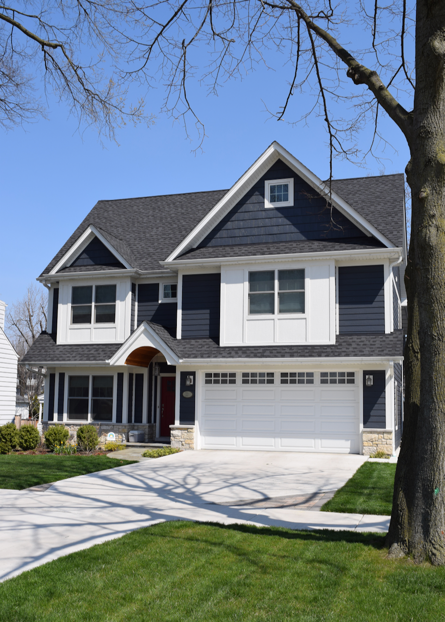 A large house with a tree in front of it
