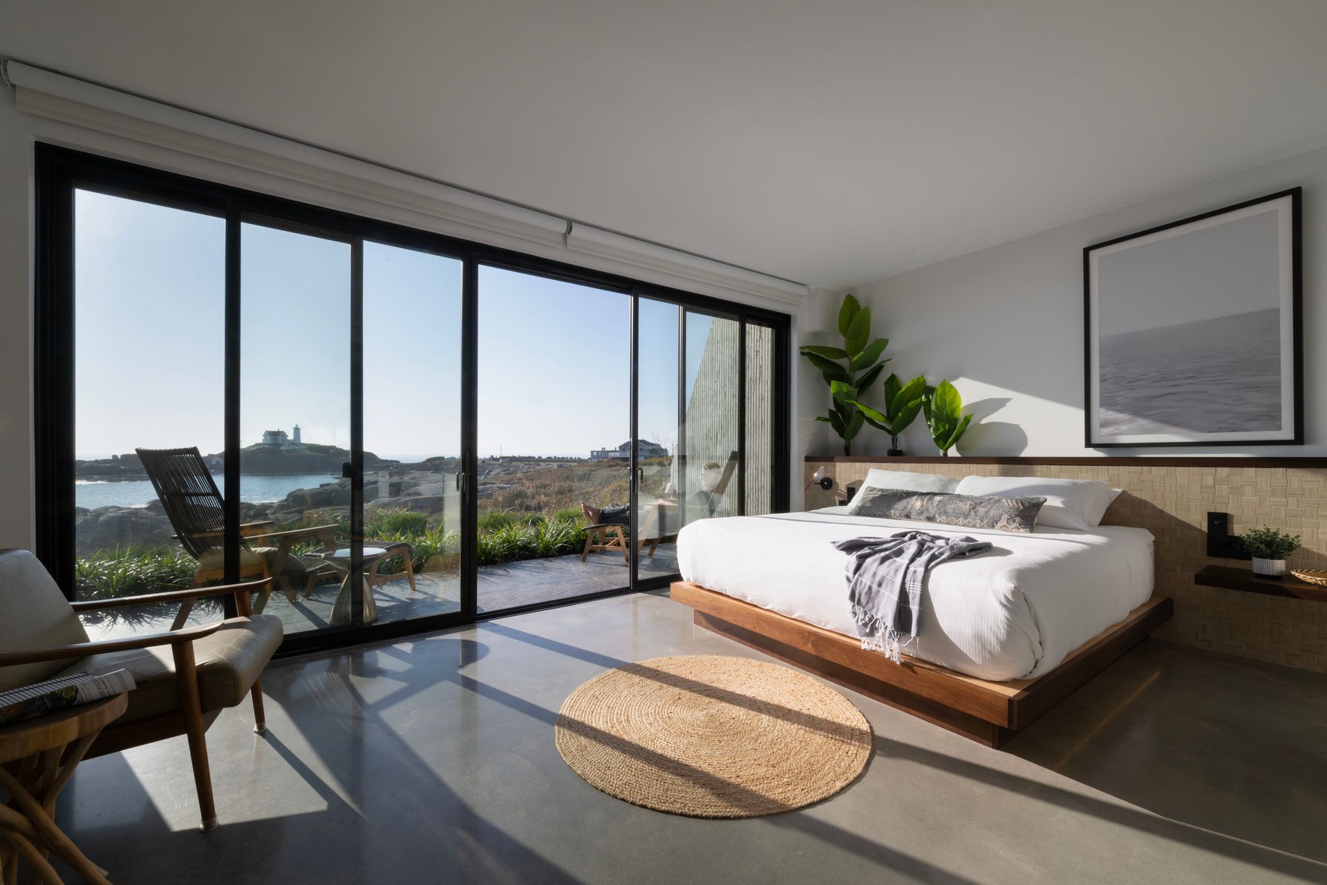A bedroom with a large bed and sliding glass doors.