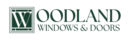 The logo for woodland windows and doors is green and white.