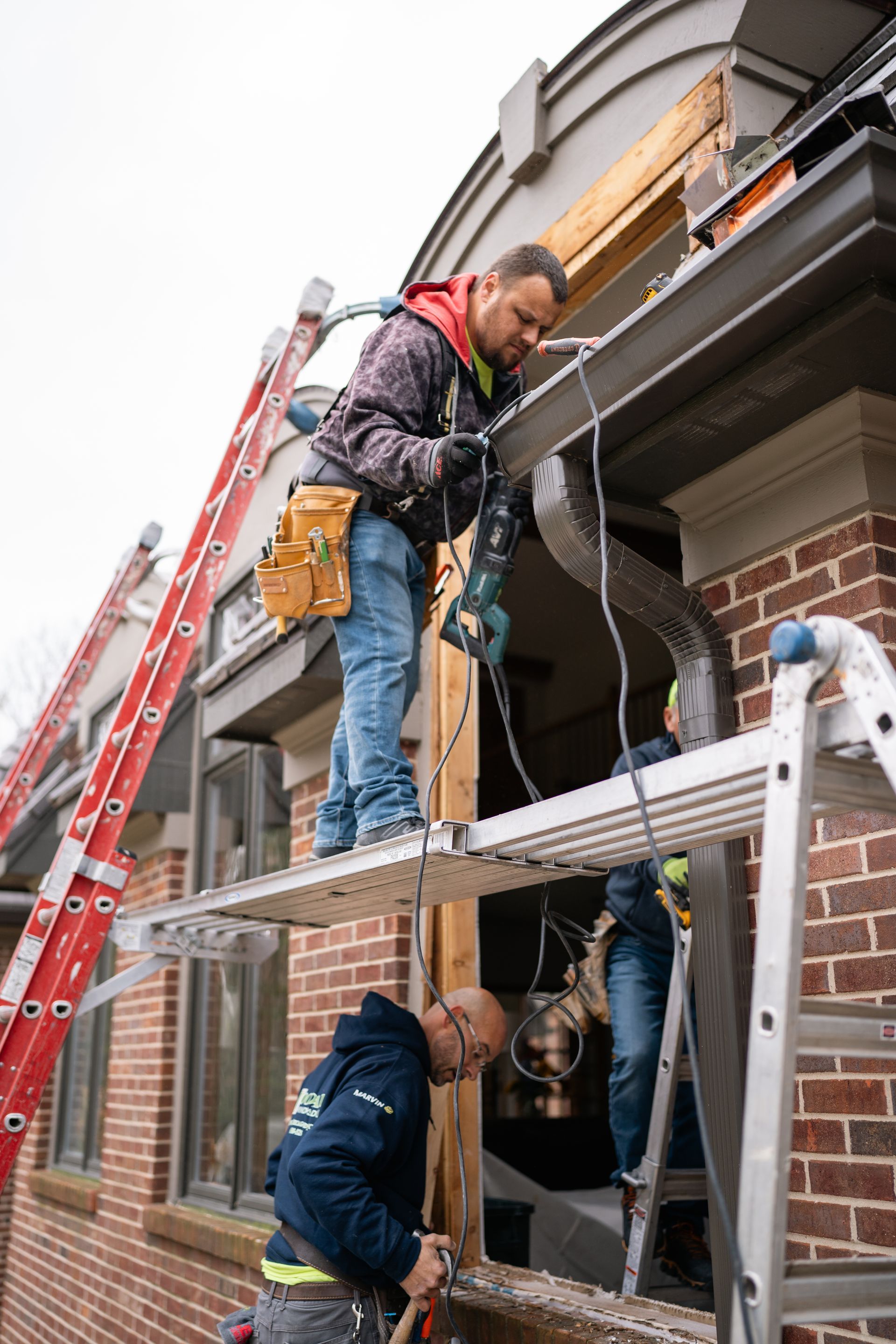 A kitchen with a large island and wooden beams on the ceiling