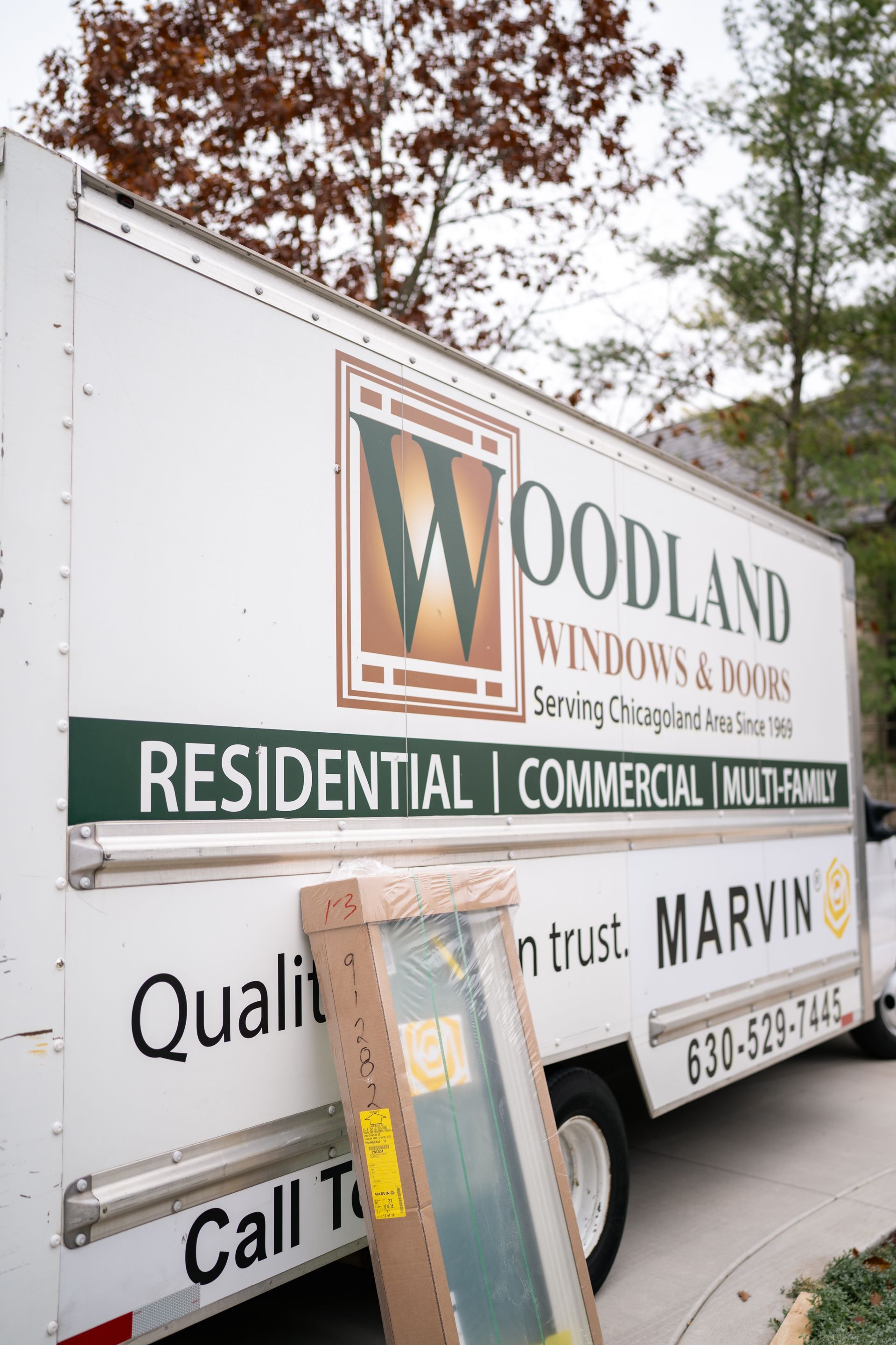 A kitchen with a large island and wooden beams on the ceiling