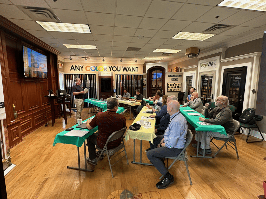 A group of people are sitting at tables in a room.