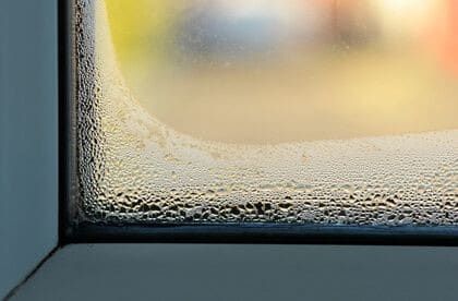 A close up of a window with condensation on it.