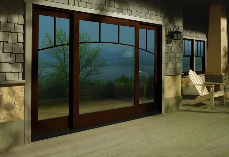 A large sliding glass door with a view of a lake