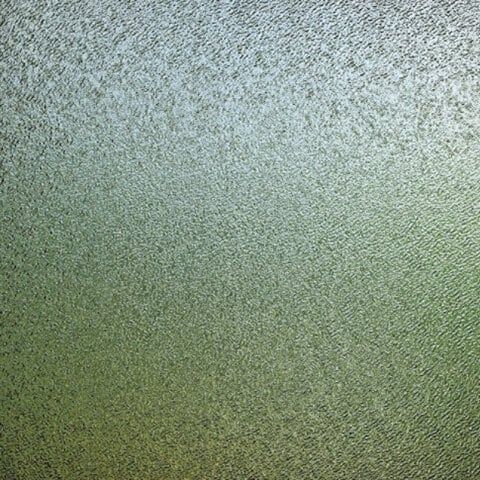 A close up of a frosted glass window with a grainy texture.
