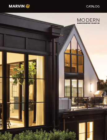 A modern house with a lot of windows and a balcony
