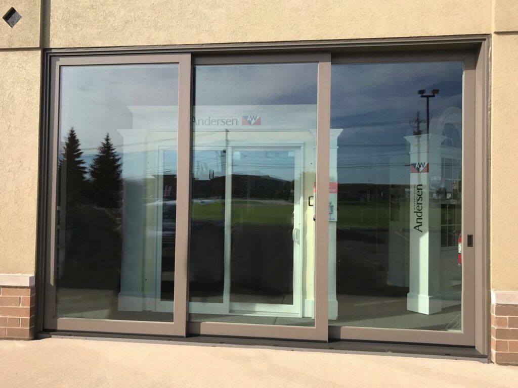 A building with a sliding glass door and a sign that says ' sliding glass door ' on it