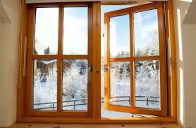 A stuck open wooden window in the winter