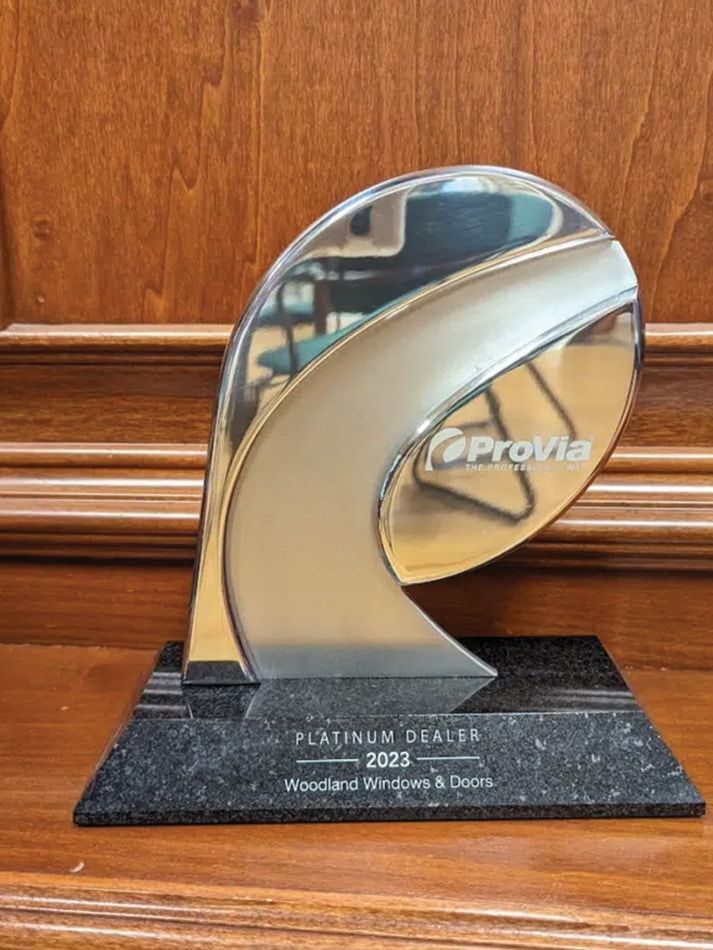 A silver trophy is sitting on top of a wooden table.