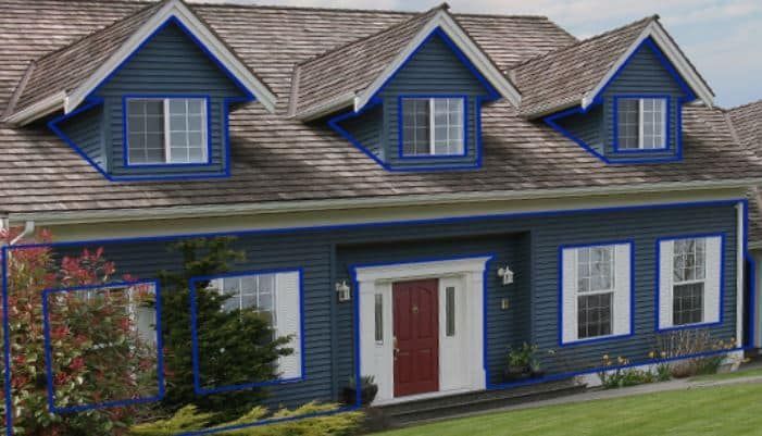 A blue house with white trim and a red door