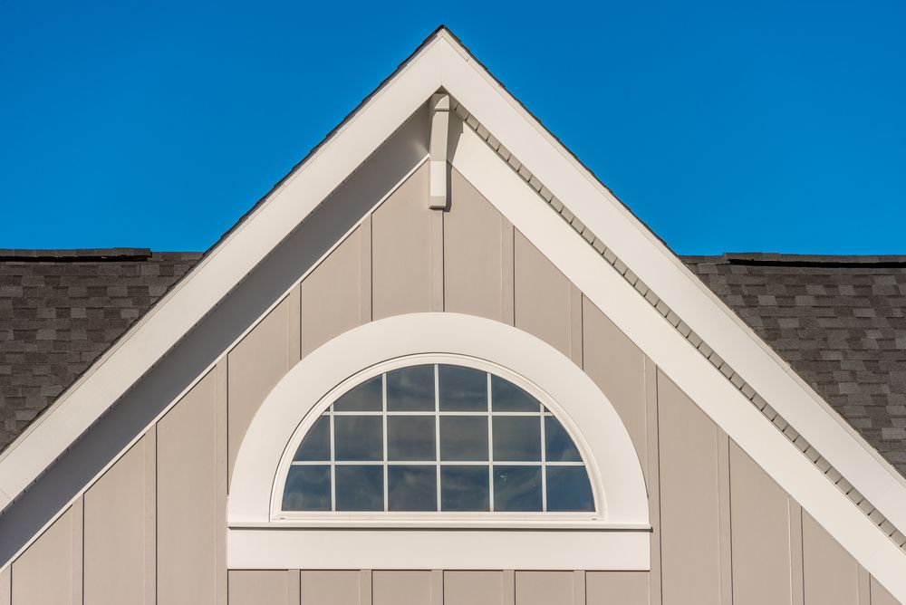 The roof of a house with a window on it