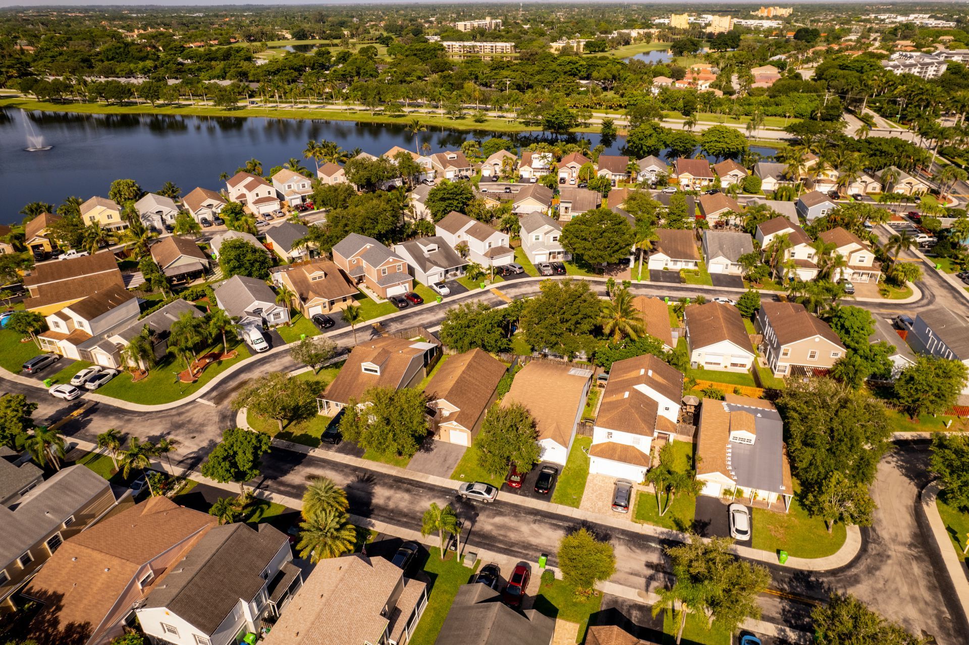 An aerial view of a residential neighborhood with a lake in the background.