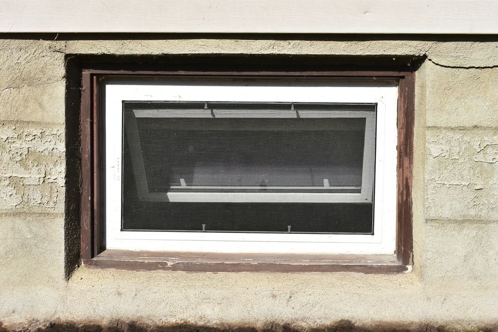 A window on a brick wall with a white frame