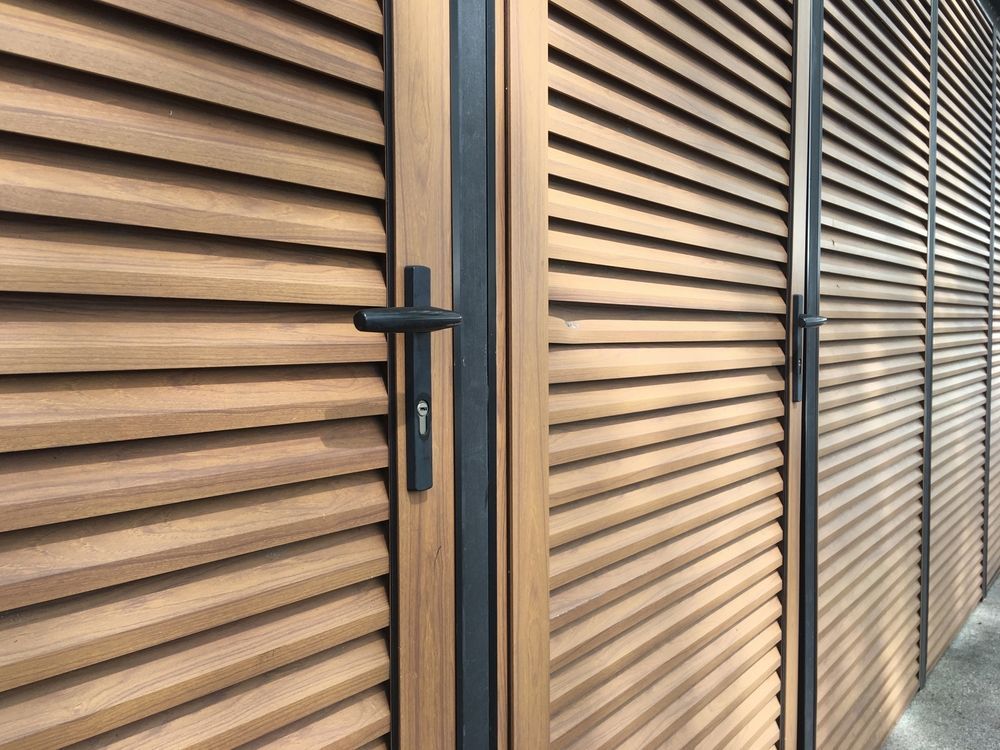 A close up of a wooden door with shutters on it.