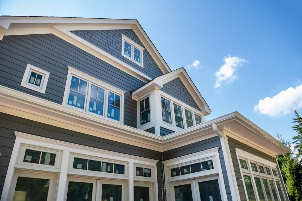 A large house with a lot of windows and a blue sky in the background.