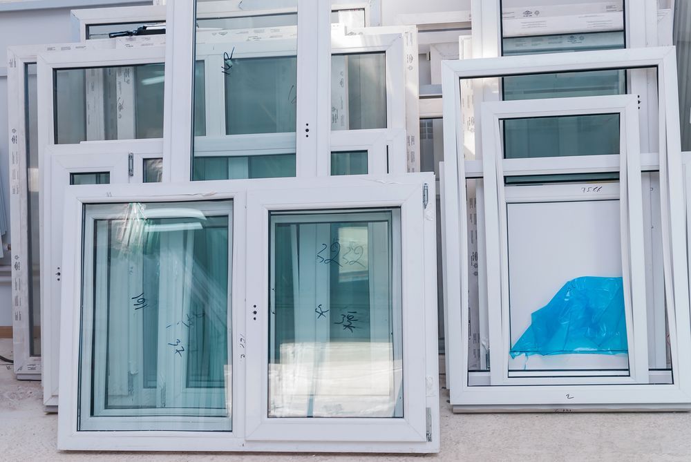 A bunch of plastic windows are stacked on top of each other.