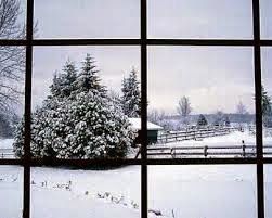 A view of a snowy field through a window.