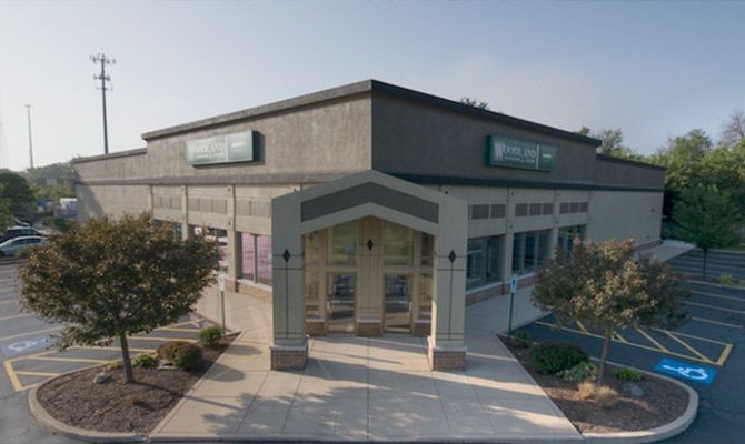 An aerial view of a building with a handicapped parking spot in front of it.