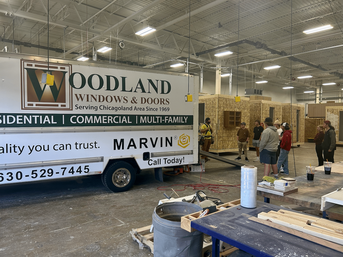 A woodland windows and doors truck is parked in a warehouse.