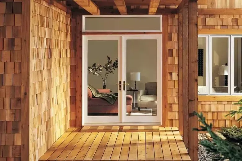 A patio with sliding glass doors leading to a living room