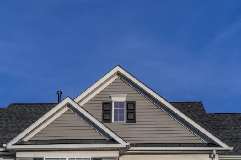 The roof of a house with a blue sky in the background