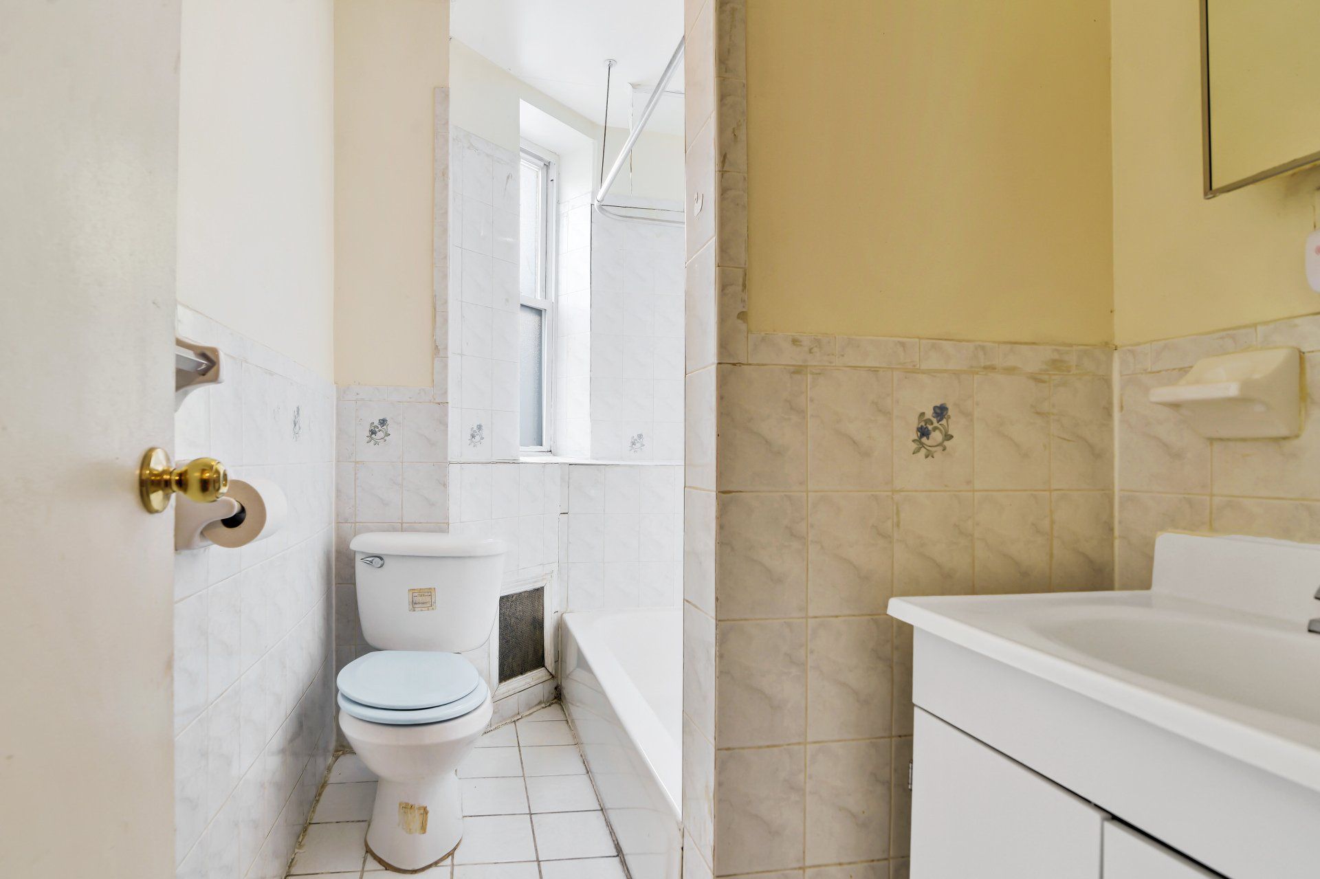 A bathroom with a toilet , sink and shower.