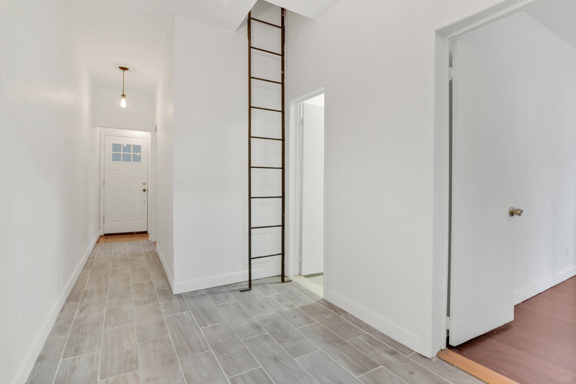 A hallway with a ladder in the middle of it
