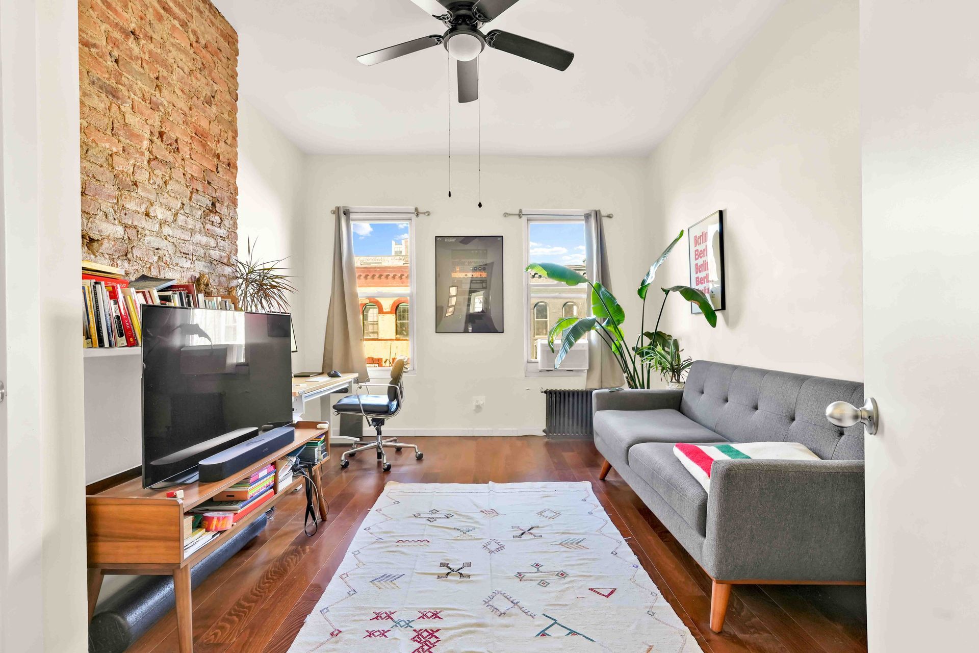 A living room with a couch and a flat screen tv