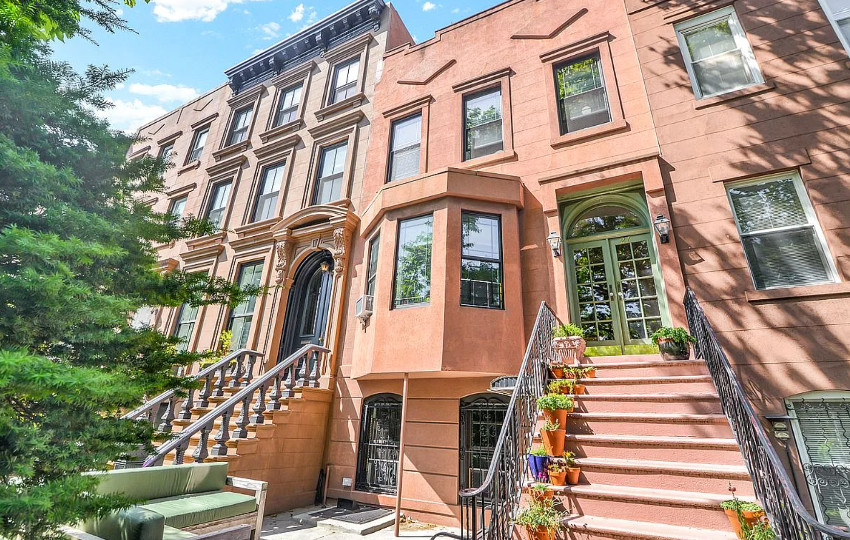 A large brown building with stairs leading up to it.