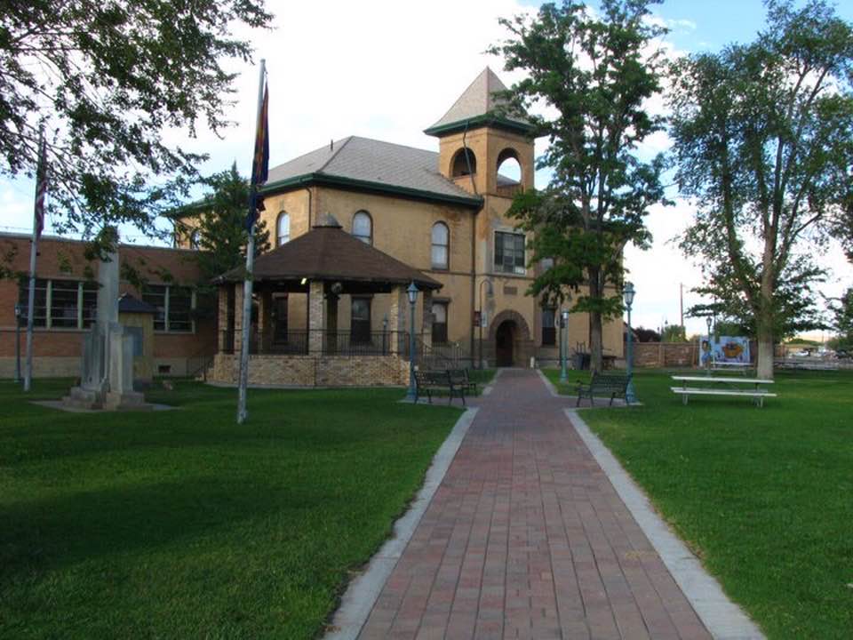 A large building with a brick walkway leading to it