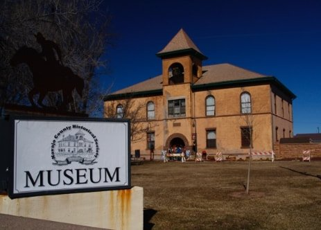 A large building with a museum sign in front of it