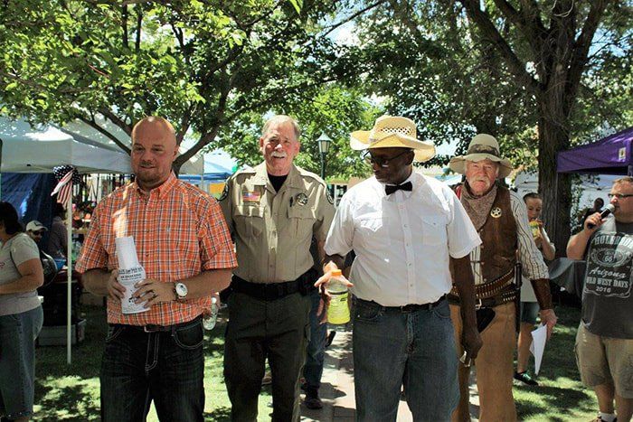 A group of men are standing next to each other in a park.