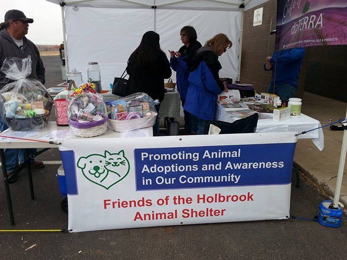 A table with a sign that says friends of the holbrook animal shelter