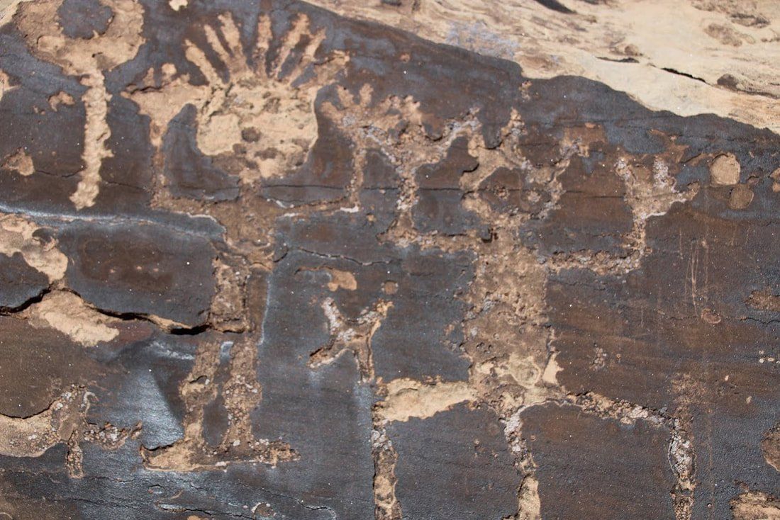 A close up of a rock with a drawing of a sun on it