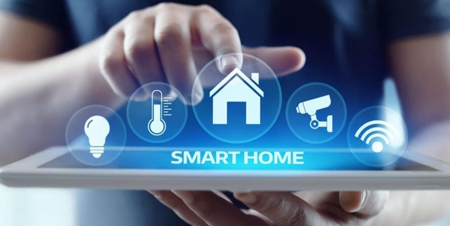 A man is using a tablet computer to control his smart home.