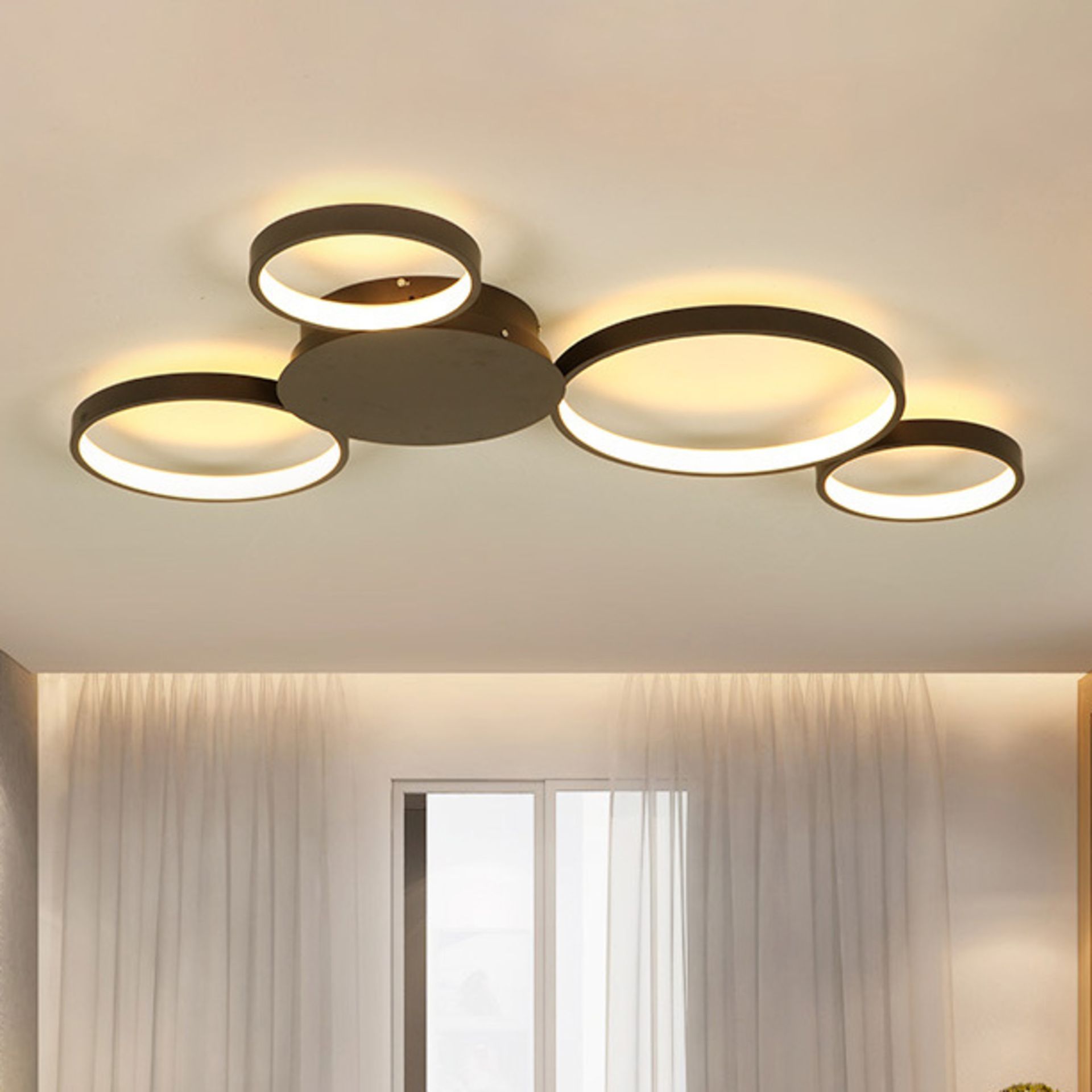 A ceiling light with three circles on it in a room.
