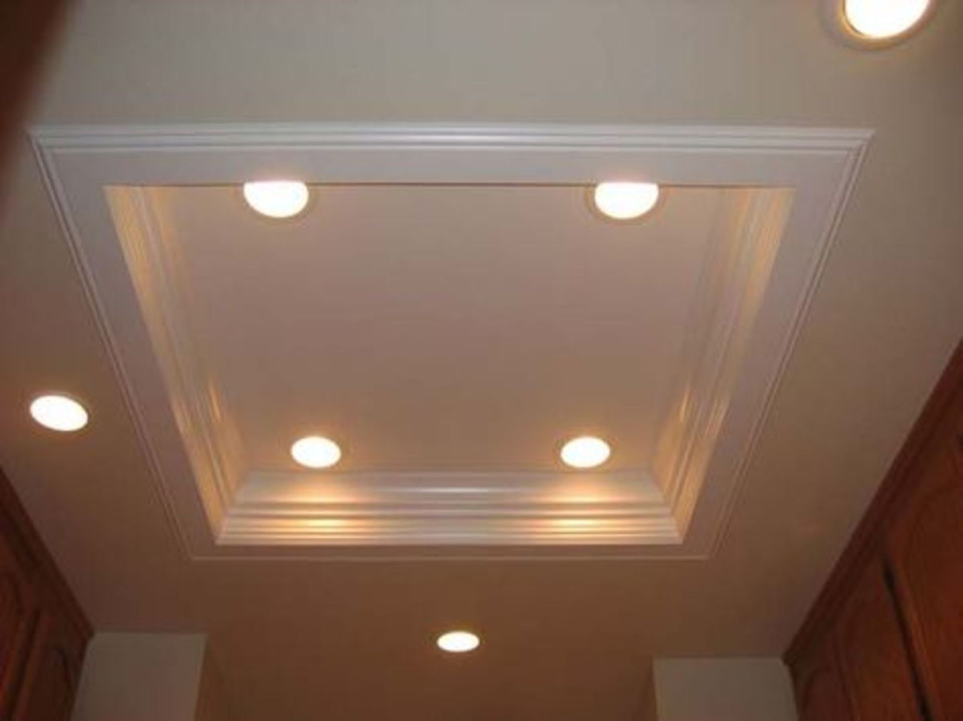 A square ceiling with four lights on it in a kitchen.