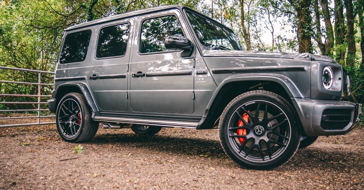 A mercedes benz g63 amg is parked on a dirt road in the woods.  | Beer's Automotive