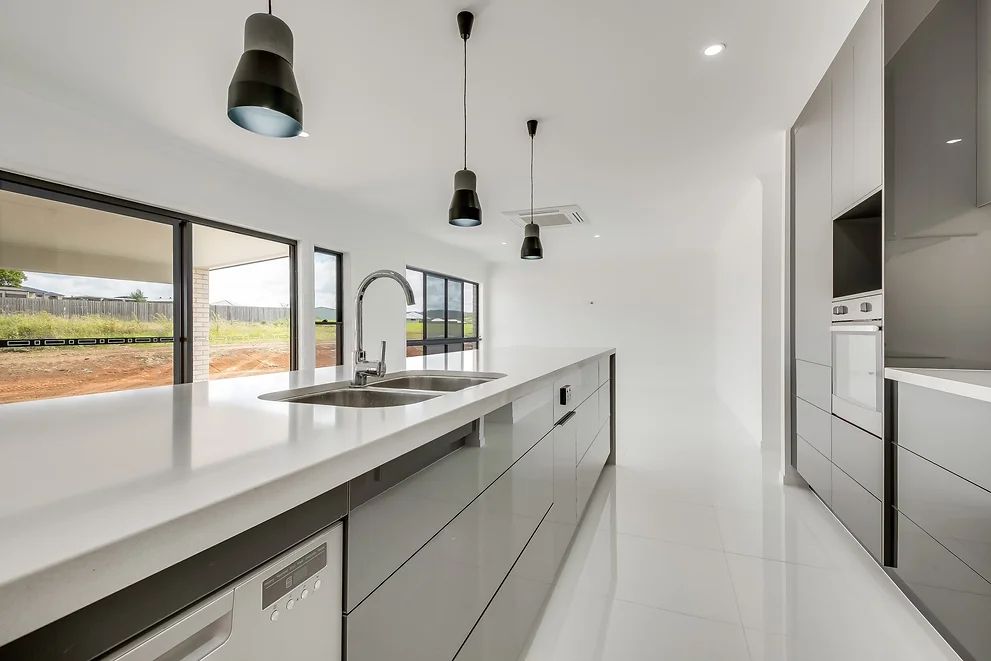 White Modern Kitchen area With Black Lights From The Ceiling — Engineering And Drafting Services In Yeppoon, QLD