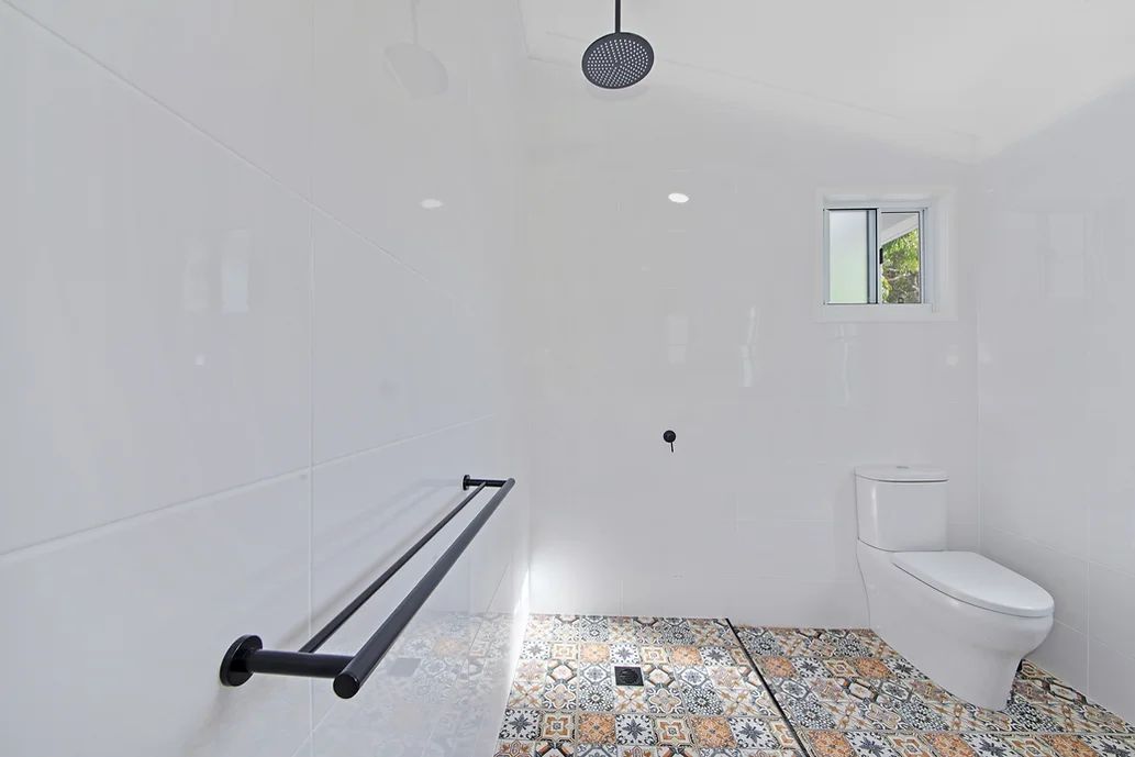 White Bathroom With Decorative Floor Tile — Engineering And Drafting Services In Yeppoon, QLD