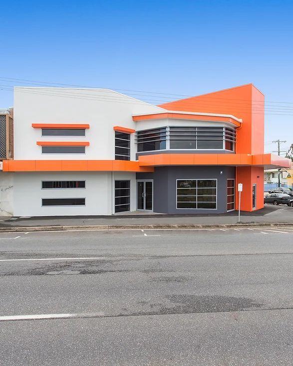 Side View of The Building with Grey Orange and White Paint — Engineering And Drafting Services In Yeppoon, QLD