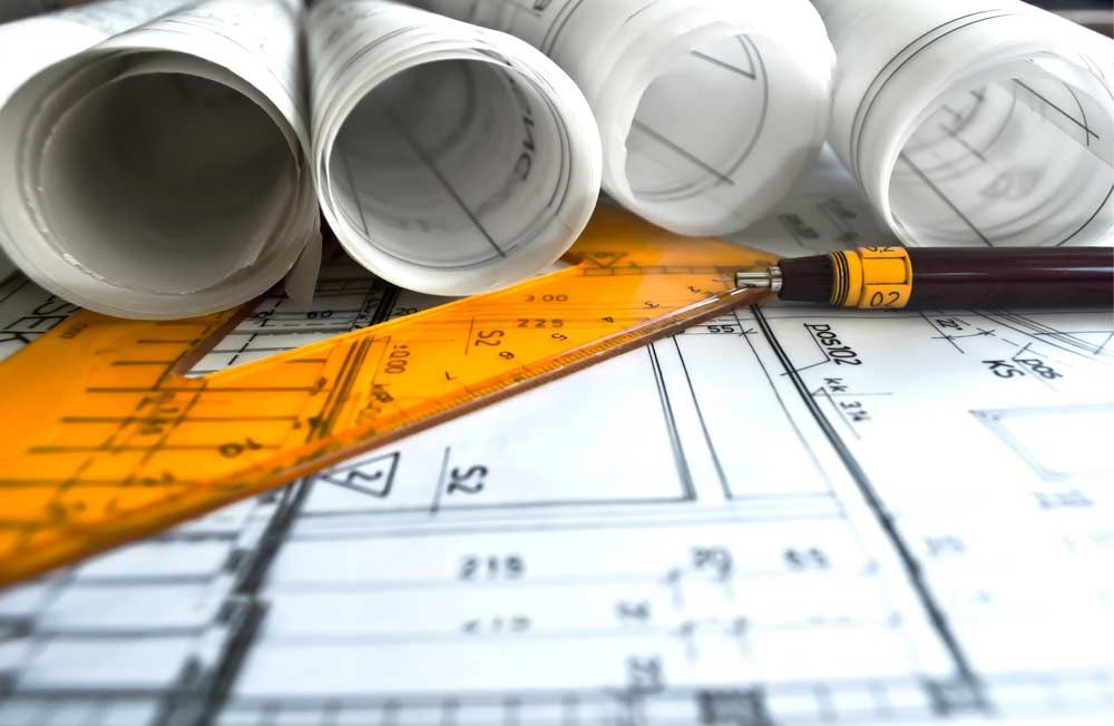 Architectural Blueprint Rolls With Ruler And Pen - Professional Engineering & Drafting Services In Rockhampton, QLD