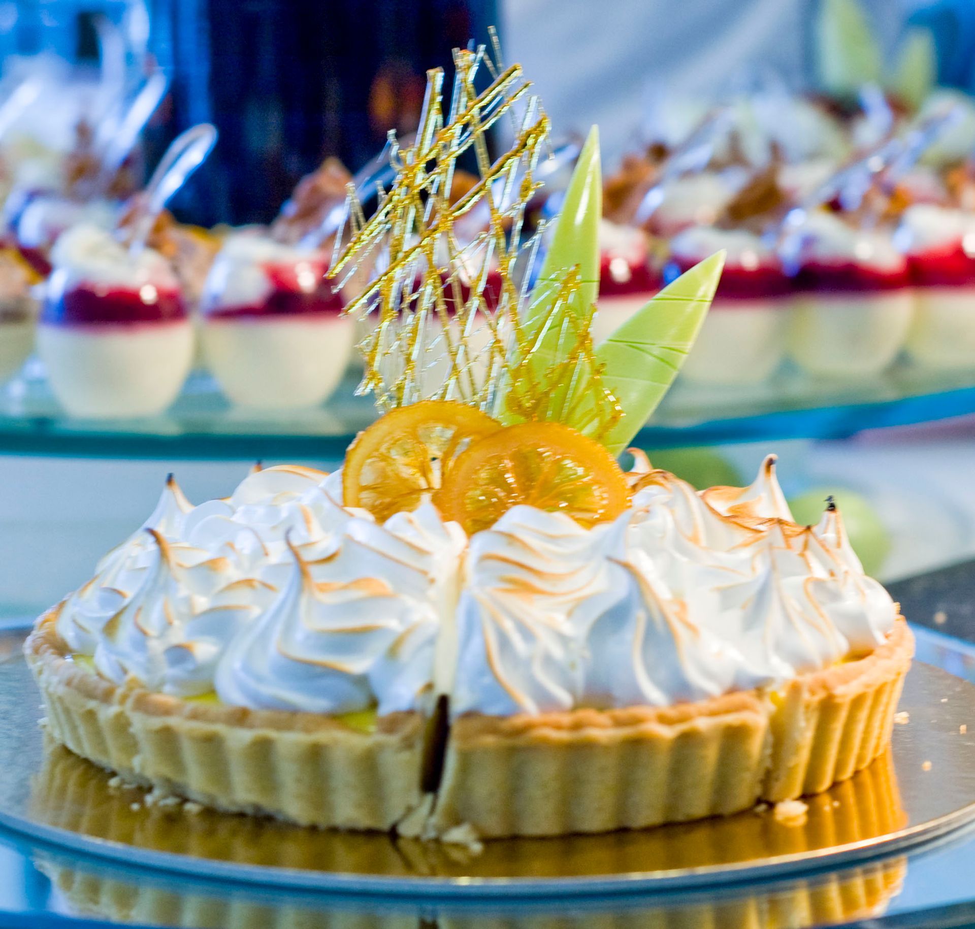 Lemon Meringue tart garnished with candied lemon, caramel and white chocolate 