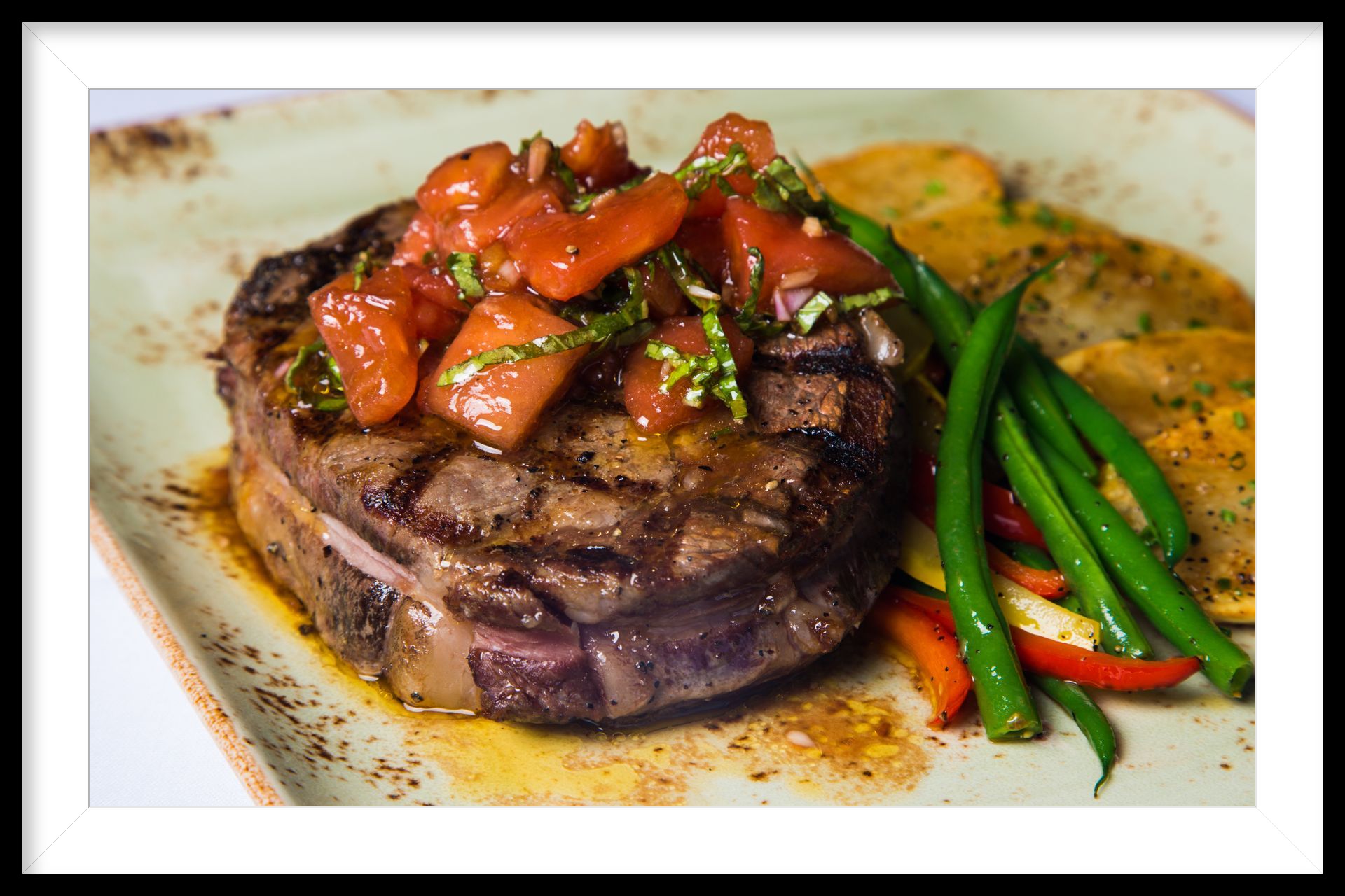 Eye of Ribeye topped with smoked tomato relish by Chef Pliska.