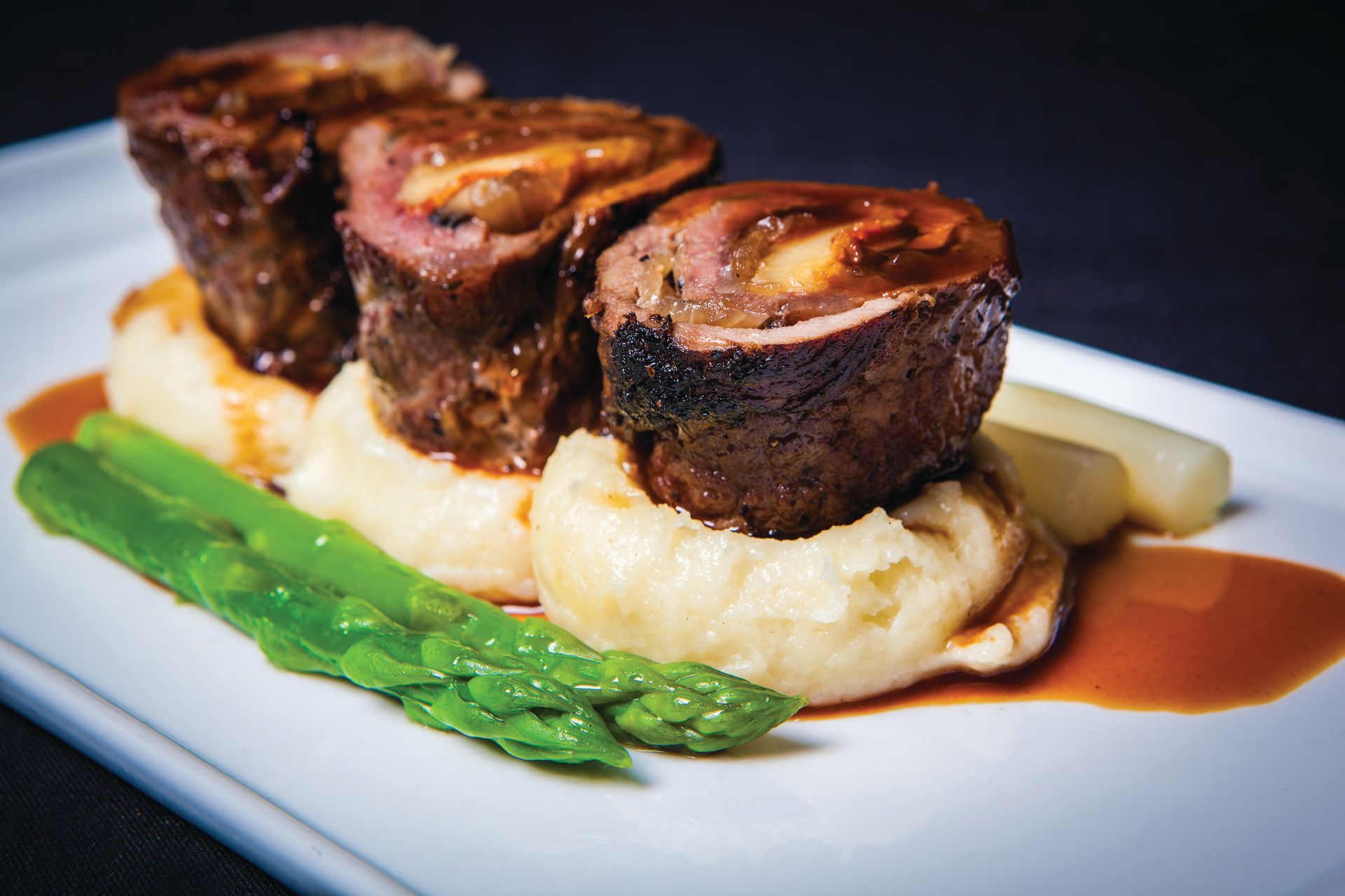 Top sirloin roulade stuffed with red onion confit, bacon, fontina cheese and grilled portabella mushroom.