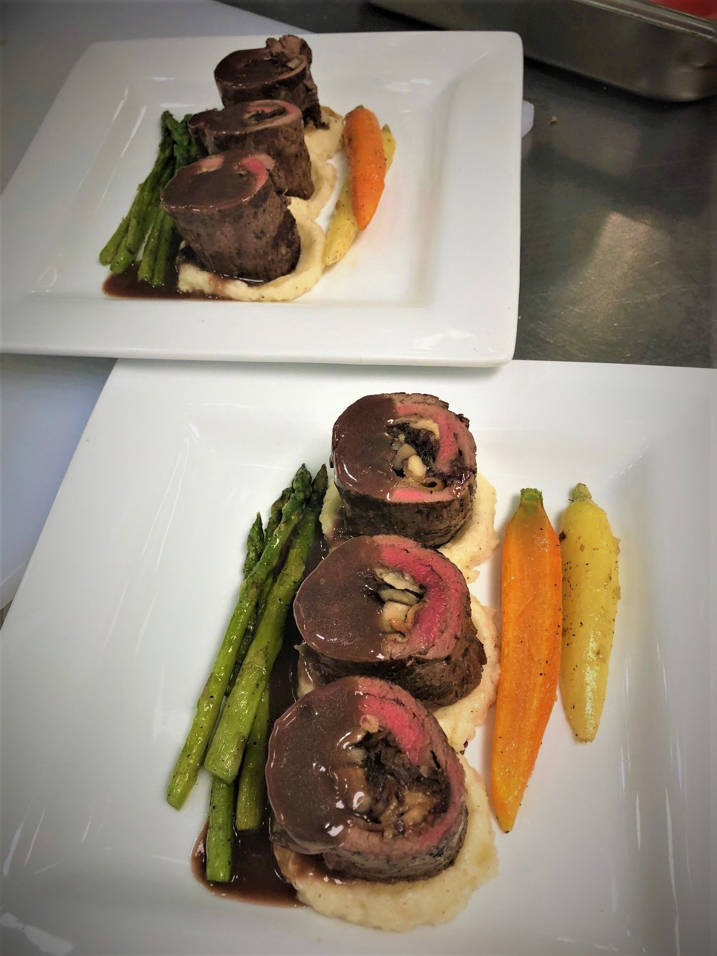 Grilled top sirloin roulade of beef served with parsnip mashed potatoes with port wine sauce.